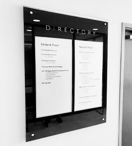 Directory on wall in greyscale